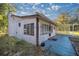 White house with covered patio, mature trees, and a yard at 11360 Se 188Th Ave, Ocklawaha, FL 32179