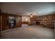 Spacious living room with wood paneling and brick fireplace at 11360 Se 188Th Ave, Ocklawaha, FL 32179