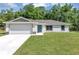 Newly built home with a two-car garage and well-manicured lawn at 13460 Sw 107 St, Dunnellon, FL 34432