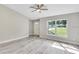 Bright living room with vinyl plank flooring and a large window at 13460 Sw 107 St, Dunnellon, FL 34432