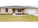Single-story house with attached garage, landscaping, and neutral color scheme at 1697 Ne 161St St, Citra, FL 32113
