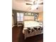 King-size bed in spacious bedroom with wood floors at 2341 Ne 42Nd St, Ocala, FL 34479