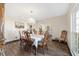 Elegant dining room with hardwood floors, chandelier, and large window at 2528 Se 15Th St, Ocala, FL 34471
