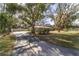 Long driveway leading to a charming home nestled among mature trees at 2528 Se 15Th St, Ocala, FL 34471