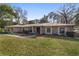 Ranch-style home with stone exterior, mature landscaping, and a spacious yard at 2528 Se 15Th St, Ocala, FL 34471