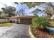 Single car garage with long driveway and mature landscaping at 2528 Se 15Th St, Ocala, FL 34471