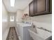 Laundry room with washer, dryer, utility sink, and cabinets at 2528 Se 15Th St, Ocala, FL 34471