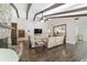 Spacious living room with hardwood floors, a stone fireplace, and a view into the kitchen at 2528 Se 15Th St, Ocala, FL 34471