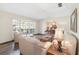 Living room featuring hardwood floors, bay window, and view into formal dining area at 2528 Se 15Th St, Ocala, FL 34471
