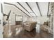 Open living room showcasing hardwood floors, vaulted ceilings with exposed beams, and comfortable seating at 2528 Se 15Th St, Ocala, FL 34471