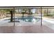 Inviting kidney-shaped pool with tiled deck and covered patio at 2528 Se 15Th St, Ocala, FL 34471