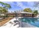 Home's back features a kidney-shaped pool and expansive patio at 2528 Se 15Th St, Ocala, FL 34471