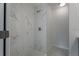 Walk-in shower with marble-look tile and glass enclosure at 5935 Nw 14Th St, Ocala, FL 34482