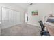 Bright bedroom with a desk and double door closet at 6084 Sw 88Th Loop, Ocala, FL 34476