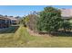 Landscaped backyard with lush greenery and spacious lawn at 8852 Se 119Th St, Summerfield, FL 34491
