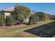 Landscaped backyard with lush green grass and manicured shrubs at 8852 Se 119Th St, Summerfield, FL 34491