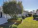 Landscaped backyard with lush green grass and manicured shrubs at 8852 Se 119Th St, Summerfield, FL 34491