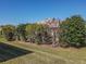 Landscaped backyard with lush green grass and manicured shrubs at 8852 Se 119Th St, Summerfield, FL 34491