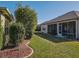 Spacious backyard with screened patio and well-maintained landscaping at 8852 Se 119Th St, Summerfield, FL 34491
