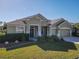 Single-story home with two-car garage and well-manicured lawn at 8852 Se 119Th St, Summerfield, FL 34491