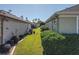 Side yard with neatly trimmed hedges and grassy area at 8852 Se 119Th St, Summerfield, FL 34491