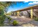 Landscaped backyard with gravel pathway and screened patio at 9015 Sw 86Th Loop, Ocala, FL 34481