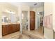 Spacious bathroom with double vanity, toilet, and access to other rooms at 9015 Sw 86Th Loop, Ocala, FL 34481