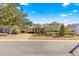 Tan one-story house with landscaped yard and paver driveway at 9015 Sw 86Th Loop, Ocala, FL 34481