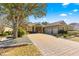 House exterior with a three-car garage and brick driveway at 9015 Sw 86Th Loop, Ocala, FL 34481