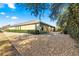 Side view of house showcasing landscaping and gravel at 9015 Sw 86Th Loop, Ocala, FL 34481