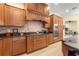 Kitchen boasts granite countertops, gas cooktop, and stylish wood cabinets at 9015 Sw 86Th Loop, Ocala, FL 34481