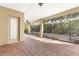 Spacious screened porch with brick pavers and ceiling fan at 9015 Sw 86Th Loop, Ocala, FL 34481