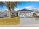 White one-story house with a two-car garage and landscaping at 9158 Sw 91St Ter, Ocala, FL 34481
