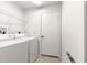 Bright laundry room with washer, dryer, and ample shelving at 9158 Sw 91St Ter, Ocala, FL 34481