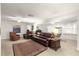Spacious living room with leather furniture and large windows at 9158 Sw 91St Ter, Ocala, FL 34481