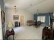 Living room with vaulted ceiling, tiled floors, and comfy seating at 9625 Sw 207Th Cir, Dunnellon, FL 34431