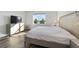 Light-filled bedroom featuring a king-size bed and a large window at 10406 Sw 96 Loop, Ocala, FL 34481