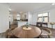 Modern dining area with a round wooden table and chairs at 10406 Sw 96 Loop, Ocala, FL 34481