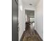 Bright entryway with dark hardwood floors and view to living room at 10406 Sw 96 Loop, Ocala, FL 34481