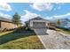 Single-story house with a gray garage door and landscaping at 10406 Sw 96 Loop, Ocala, FL 34481