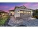 One-story home with gray garage door and paved driveway at 10406 Sw 96 Loop, Ocala, FL 34481