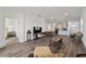 Living room with hardwood floors, furniture and view into kitchen at 10406 Sw 96 Loop, Ocala, FL 34481