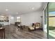 Open living space with wood-look floors and access to patio at 10406 Sw 96 Loop, Ocala, FL 34481