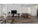 Open concept living space with hardwood floors and views to bedroom and kitchen at 10406 Sw 96 Loop, Ocala, FL 34481