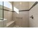 Walk-in shower with neutral tile, seat, and grab bar at 10406 Sw 96 Loop, Ocala, FL 34481