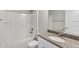 Bathroom with granite countertop, white cabinets, and a shower/tub combo at 122 Pine Trce, Ocala, FL 34472