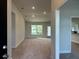 Bright and spacious entryway with high ceilings and carpeted floor at 3 Willow Trl, Ocala, FL 34472