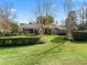 Landscaped backyard with lush lawn and view of home at 3000 Nw 79Th Avenue Rd, Ocala, FL 34482