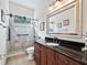 Elegant bathroom with dark vanity, large mirror, and a glass shower enclosure at 3000 Nw 79Th Avenue Rd, Ocala, FL 34482