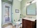Powder room with a pedestal sink and access to the backyard at 3000 Nw 79Th Avenue Rd, Ocala, FL 34482